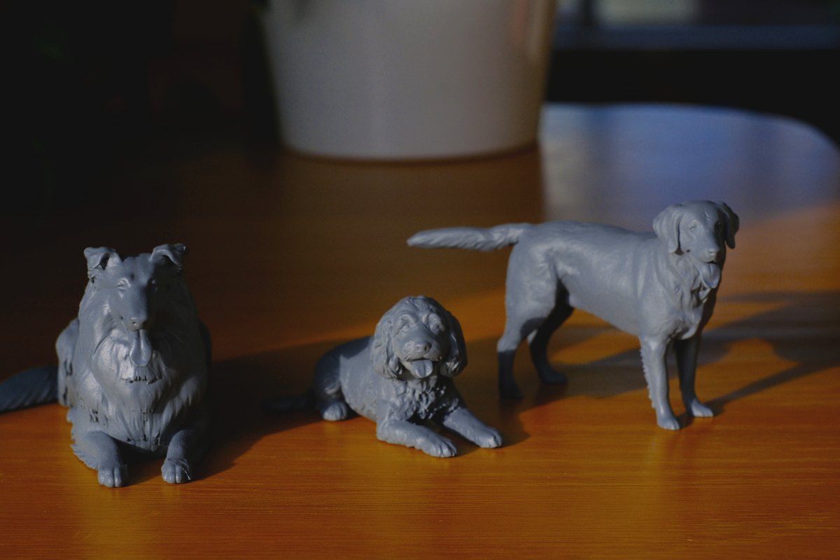Grey primed resin pet figurines showing different pose options